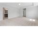 Carpeted main bedroom featuring tray ceilings and ensuite bath access at 257 North Maple Walk Dr # 218, Garner, NC 27529