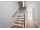 Staircase featuring hardwood treads, white risers, and natural wood handrail leading to upper level at 257 North Maple Walk Dr # 218, Garner, NC 27529