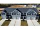 Three-unit townhome building with gray siding and two-car garages at 285 Moyer Dr # 119, Graham, NC 27253