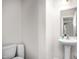 Small bathroom with pedestal sink and toilet at 326 Armistead Ct, Burlington, NC 27217