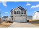 Two-story house with gray siding, a white garage door, and a well-maintained lawn at 326 Armistead Ct, Burlington, NC 27217