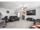 Living room with large TV, leather couches, and a ceiling fan at 326 Armistead Ct, Burlington, NC 27217