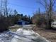 Gravel driveway leading to a blue house and garage at 3612 Mt Zion Church Rd, Mebane, NC 27302