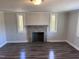 Living room features hardwood floors and a brick fireplace at 3612 Mt Zion Church Rd, Mebane, NC 27302