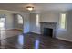 Living room with hardwood floors, fireplace, and archway to dining area at 3612 Mt Zion Church Rd, Mebane, NC 27302