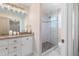 Bathroom with granite vanity, white cabinets, and walk-in shower at 402 W Clay St, Mebane, NC 27302