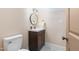 Clean bathroom with toilet and a dark brown vanity at 402 W Clay St, Mebane, NC 27302