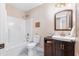 Clean bathroom with a vanity, toilet, and shower/tub combo at 402 W Clay St, Mebane, NC 27302