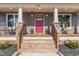Front entry with red door and stone accents at 402 W Clay St, Mebane, NC 27302