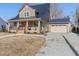 Two-story home with a gray exterior and stone accents at 402 W Clay St, Mebane, NC 27302