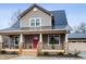 Charming two-story home with metal roof, inviting front porch, and attached garage at 402 W Clay St, Mebane, NC 27302