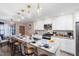 Bright kitchen with granite countertops, an island with seating, and modern appliances at 402 W Clay St, Mebane, NC 27302