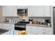 Well-equipped kitchen with stainless steel appliances and granite countertops at 402 W Clay St, Mebane, NC 27302