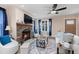 Cozy living room with a stone fireplace, ceiling fan, and large window at 402 W Clay St, Mebane, NC 27302