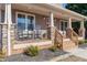 Front porch with rocking chairs and stone pillars at 402 W Clay St, Mebane, NC 27302