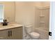 This bathroom features a single vanity with a quartz countertop and a shower-tub combo with white tile at 4321 Darius Ln # 23, Fuquay Varina, NC 27526