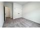 A clean bedroom with soft gray carpet, white walls, and a view into the hall showcases its roomy layout at 4321 Darius Ln # 23, Fuquay Varina, NC 27526