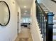 Bright hallway with hardwood floors and staircase with black iron spindles at 4321 Darius Ln # 23, Fuquay Varina, NC 27526