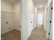 Bright hallway featuring wood-look flooring, white walls, and access to various rooms, including the laundry at 4321 Darius Ln # 23, Fuquay Varina, NC 27526