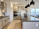 Modern kitchen with stainless appliances, large island, and stylish pendant lighting at 4321 Darius Ln # 23, Fuquay Varina, NC 27526
