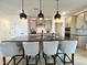 Kitchen island with bar stool seating and modern pendant lights at 4321 Darius Ln # 23, Fuquay Varina, NC 27526