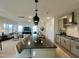 Open kitchen island with seating overlooks the adjacent living room area at 4321 Darius Ln # 23, Fuquay Varina, NC 27526