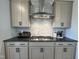 Well-equipped kitchen featuring modern cabinets, stainless steel range hood, and a sleek gas cooktop at 4321 Darius Ln # 23, Fuquay Varina, NC 27526