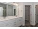 Double vanity bathroom with a large mirror and shower at 572 Glenkirk Pl, Garner, NC 27529