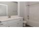 Modern bathroom with white vanity, tub, and shower at 572 Glenkirk Pl, Garner, NC 27529
