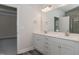Double vanity bathroom with mirror and access to bedroom at 572 Glenkirk Pl, Garner, NC 27529