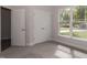 Bright bedroom with a large window, carpet, and double door closet at 572 Glenkirk Pl, Garner, NC 27529