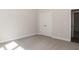 Well-lit bedroom featuring carpet and a double door closet at 572 Glenkirk Pl, Garner, NC 27529