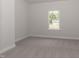 Simple bedroom with window and grey carpet at 572 Glenkirk Pl, Garner, NC 27529