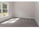 Bright bedroom with grey carpet and large window at 572 Glenkirk Pl, Garner, NC 27529