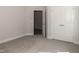 Spacious bedroom with carpet flooring and an open door to another room at 572 Glenkirk Pl, Garner, NC 27529