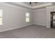 Primary bedroom with two windows and carpet at 572 Glenkirk Pl, Garner, NC 27529