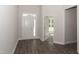 Bright entryway with hardwood floors, white door, and access to another room at 572 Glenkirk Pl, Garner, NC 27529