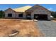 New construction home featuring a two-car garage, and a large front yard waiting for landscaping at 572 Glenkirk Pl, Garner, NC 27529