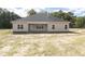 Tan house with covered patio and large backyard at 572 Glenkirk Pl, Garner, NC 27529