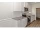 Modern kitchen with white cabinets, granite countertops, and stainless steel range at 572 Glenkirk Pl, Garner, NC 27529