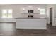 Modern kitchen with white cabinets, granite counters, and stainless steel appliances at 572 Glenkirk Pl, Garner, NC 27529