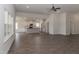 Open living room with hardwood floors, lots of natural light, and views to kitchen at 572 Glenkirk Pl, Garner, NC 27529