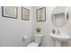 Small half bathroom with pedestal sink and simple decor at 5929 Sodium St, Raleigh, NC 27610