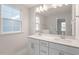 Bathroom featuring a double vanity with a large mirror and modern fixtures at 704 Georgia'S Landing Pkwy # 15, Raleigh, NC 27603