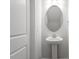 Small bathroom features a pedestal sink with oval mirror at 704 Georgia'S Landing Pkwy # 15, Raleigh, NC 27603