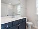 Modern bathroom features a blue vanity with white countertop, toilet and shower at 704 Georgia'S Landing Pkwy # 15, Raleigh, NC 27603