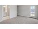 Open bedroom with carpet, bathroom, and access to covered patio at 704 Georgia'S Landing Pkwy # 15, Raleigh, NC 27603
