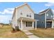 Exterior of a two-story home with gray siding, white trim, and a covered porch at 704 Georgia'S Landing Pkwy # 15, Raleigh, NC 27603