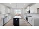 Bright kitchen with white cabinets, island, stainless appliances, and stylish subway tile backsplash at 704 Georgia'S Landing Pkwy # 15, Raleigh, NC 27603