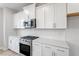 Modern kitchen with stainless steel stove, microwave, white countertops, and subway tile backsplash at 704 Georgia'S Landing Pkwy # 15, Raleigh, NC 27603